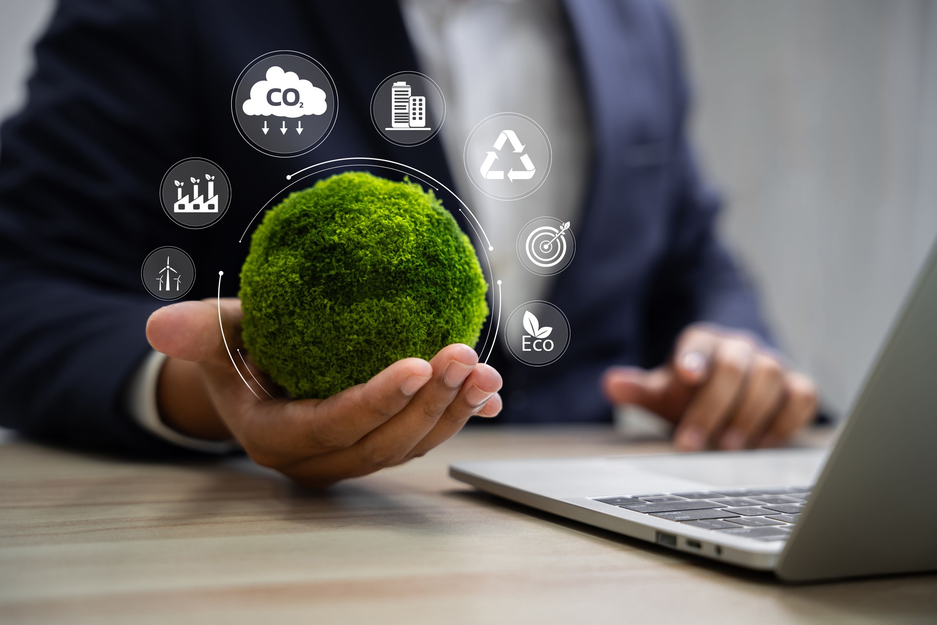 World environment day, Responsibility for a green planet, Sustainable growth, and global conservation.Businessman holding green world, Sustainable development goals and corporate social responsibility