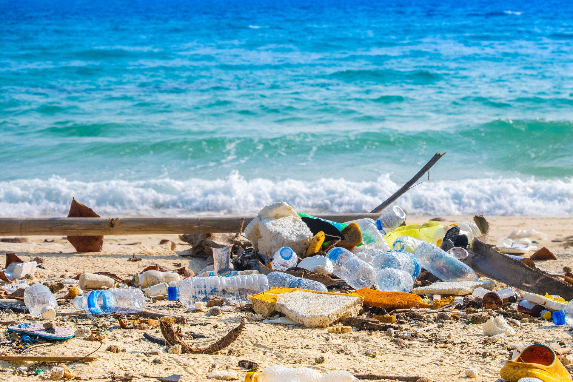 trash, plastic cups and plastic bags at the beach. environmental problem concept and healing the world
